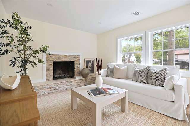 living room featuring healthy amount of natural light and a fireplace