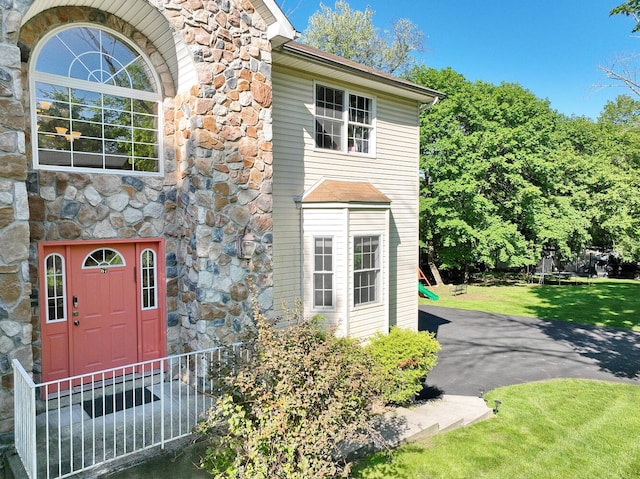 67 N Airmont Rd, Suffern, NY 10901 - view of front of property with stone siding and a front lawn