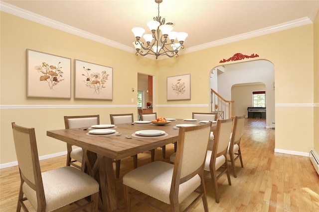 67 N Airmont Rd, Suffern, NY 10901 - dining area with arched walkways, light wood finished floors, a chandelier, crown molding, and stairway