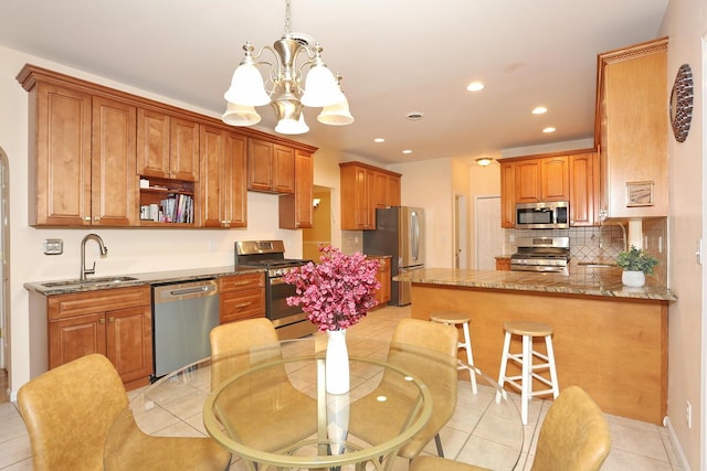 67 N Airmont Rd, Suffern, NY 10901 - kitchen with stainless steel appliances, a sink, a chandelier, recessed lighting, and decorative backsplash