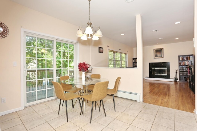 67 N Airmont Rd, Suffern, NY 10901 - dining space featuring a baseboard heating unit, healthy amount of natural light, a glass covered fireplace, a chandelier, and recessed lighting