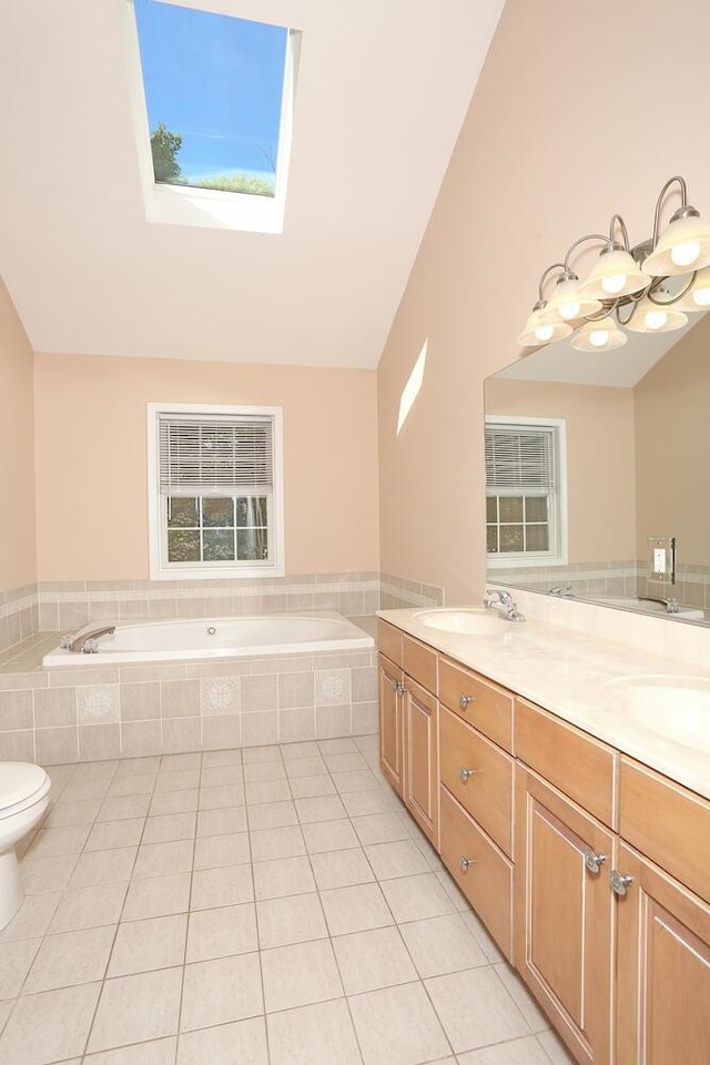 67 N Airmont Rd, Suffern, NY 10901 - bathroom with a skylight, a garden tub, tile patterned flooring, double vanity, and vaulted ceiling