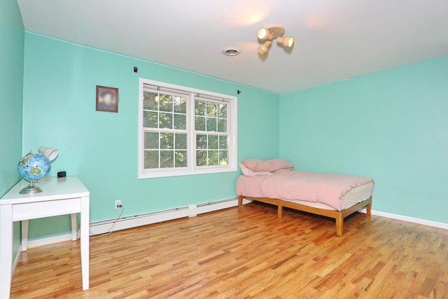 67 N Airmont Rd, Suffern, NY 10901 - bedroom featuring a baseboard radiator, light wood-type flooring, and baseboards