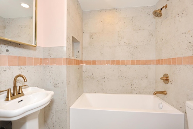 67 N Airmont Rd, Suffern, NY 10901 - bathroom featuring tile walls, a sink, a tub to relax in, and toilet