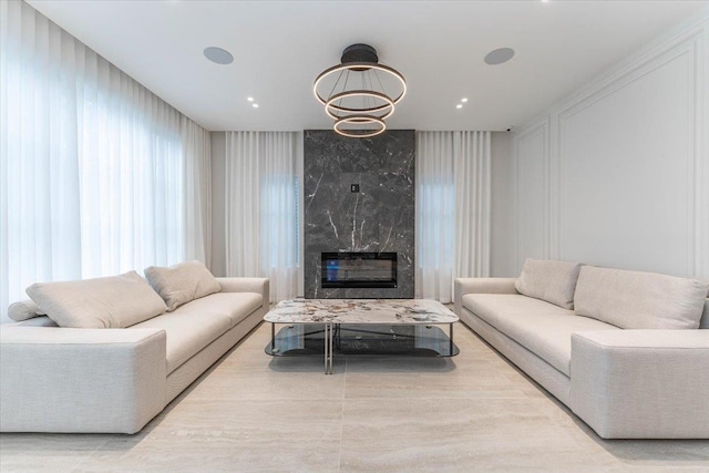 357 Argyle, Cedarhurst, NY 11516 - living room featuring a fireplace and a chandelier