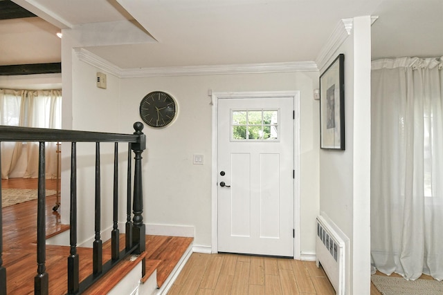 45 Longworth Ave, Dix Hills, NY 11746 - foyer featuring radiator heating unit, light wood finished floors, baseboards, crown molding, and stairway