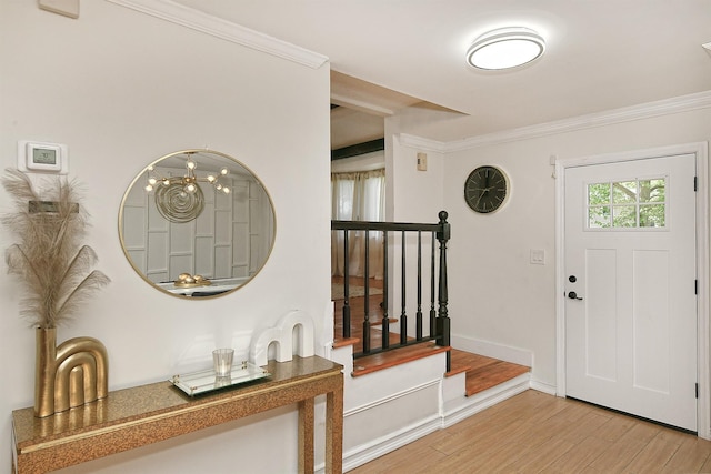 45 Longworth Ave, Dix Hills, NY 11746 - entrance foyer with light wood-type flooring, crown molding, baseboards, and stairway