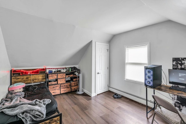 17 Lexington Rd, Shirley, NY 11967 - bonus room featuring vaulted ceiling, a baseboard radiator, and wood finished floors