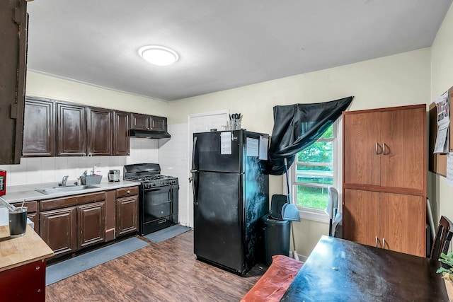 625 Scherger Ave, East Patchogue, NY 11772 - kitchen with black appliances, a sink, under cabinet range hood, dark wood-type flooring, and light countertops