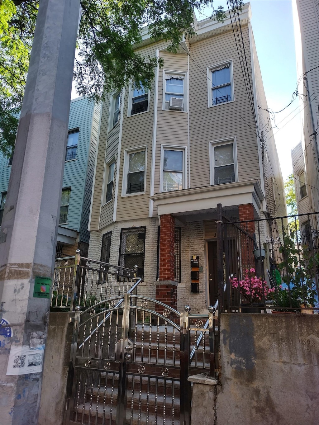 1019 Woodycrest Ave, Bronx, NY 10452 - view of property featuring a gate, brick siding, and a fenced front yard