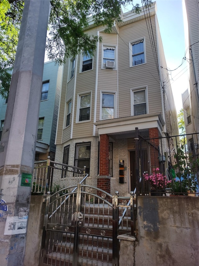 1019 Woodycrest Ave, Bronx, NY 10452 - view of property featuring a gate, brick siding, and a fenced front yard
