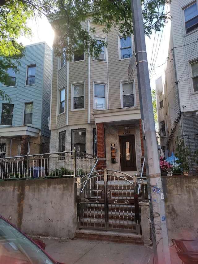 1019 Woodycrest Ave, Bronx, NY 10452 - townhome / multi-family property featuring a fenced front yard and brick siding