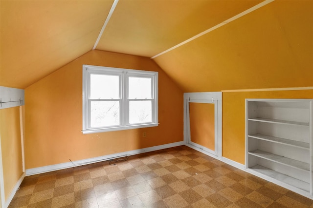 21 Patricia Ave, Fishkill, NY 12524 - additional living space featuring baseboards, vaulted ceiling, tile patterned floors, and built in shelves