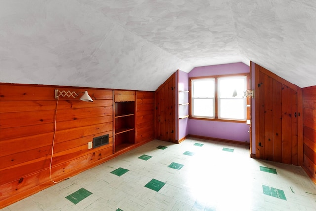 21 Patricia Ave, Fishkill, NY 12524 - additional living space featuring built in shelves, wooden walls, lofted ceiling, and a textured ceiling