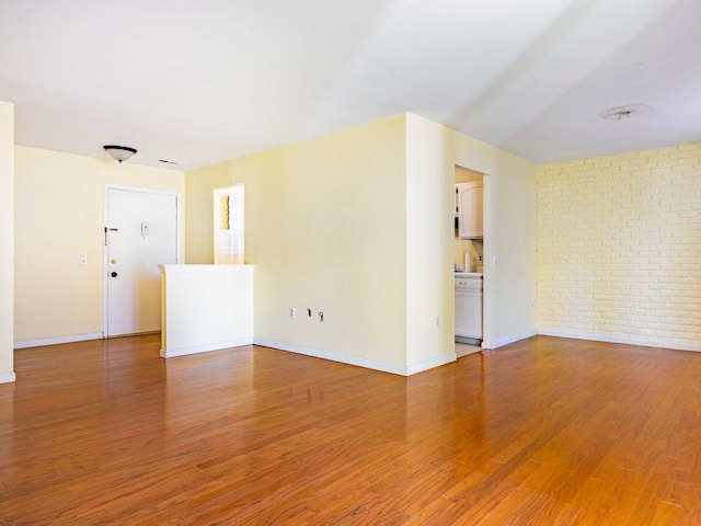 902 Commons Way Unit B, Fishkill, NY 12524 - spare room with baseboards, light wood-style floors, and brick wall