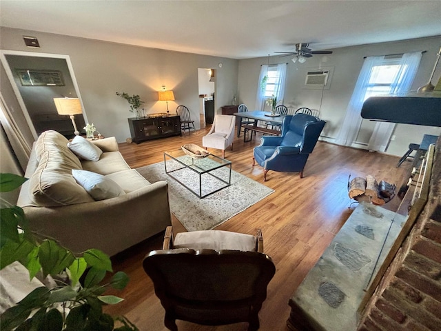 49 N Chestnut St, Beacon, NY 12508 - living area featuring a ceiling fan, wood finished floors, and a wall unit AC