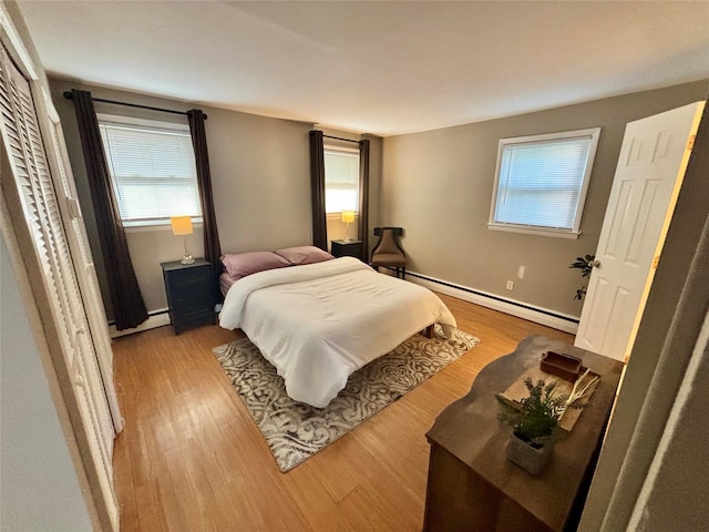 49 N Chestnut St, Beacon, NY 12508 - bedroom with baseboard heating, wood finished floors, and multiple windows