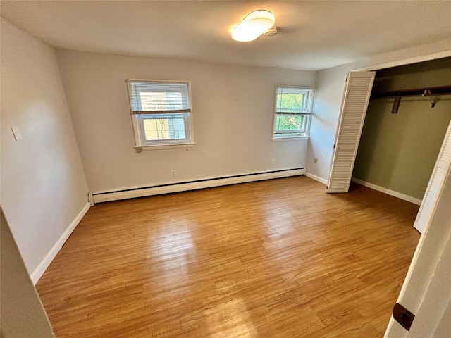 49 N Chestnut St, Beacon, NY 12508 - unfurnished bedroom with a baseboard radiator, wood finished floors, and a closet