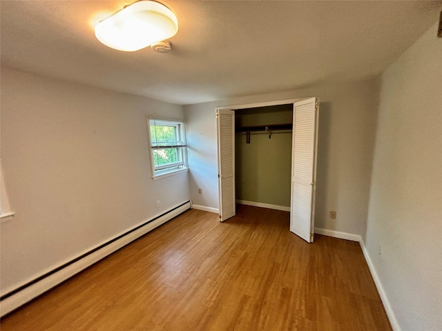 49 N Chestnut St, Beacon, NY 12508 - unfurnished bedroom featuring a baseboard radiator, wood finished floors, and a closet