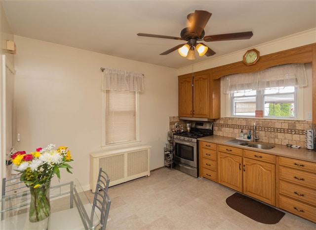 964 Pemart Ave, Peekskill, NY 10566 - kitchen with stainless steel gas range, radiator, a sink, tasteful backsplash, and a ceiling fan
