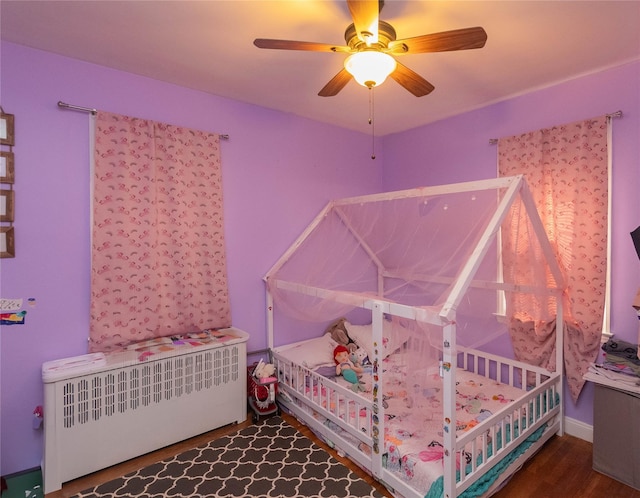 964 Pemart Ave, Peekskill, NY 10566 - bedroom with wood finished floors, ceiling fan, and radiator