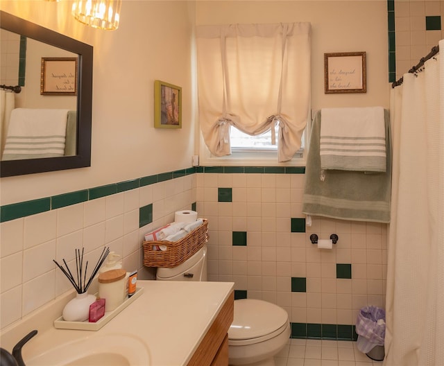 964 Pemart Ave, Peekskill, NY 10566 - full bathroom with tile walls, vanity, toilet, wainscoting, and tile patterned flooring