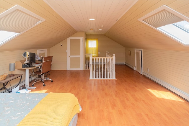 964 Pemart Ave, Peekskill, NY 10566 - bedroom featuring a skylight, wooden walls, wood finished floors, lofted ceiling, and a desk