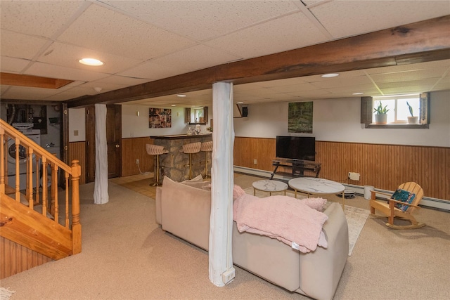 964 Pemart Ave, Peekskill, NY 10566 - carpeted living room with wainscoting, a drop ceiling, wood walls, bar area, and a baseboard heating unit