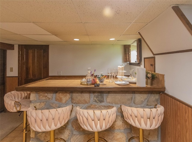 964 Pemart Ave, Peekskill, NY 10566 - bar featuring wainscoting, a drop ceiling, wood walls, tile patterned flooring, and recessed lighting