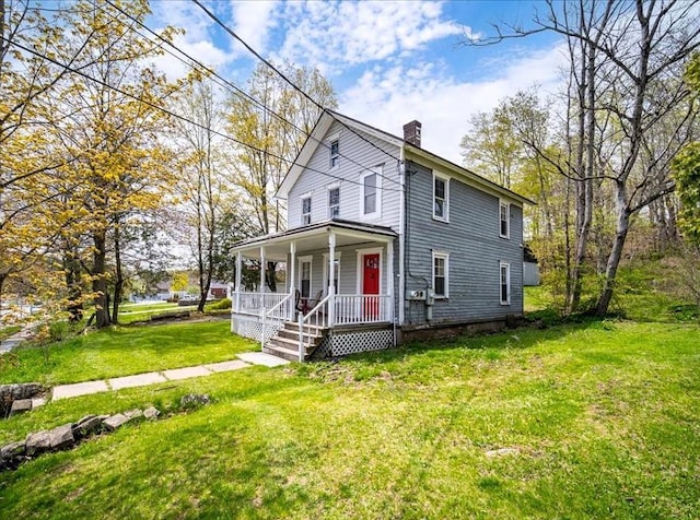 239-241 Hurleyville Main St, Hurleyville, NY 12747 - view of front of house featuring a porch, a chimney, and a front yard