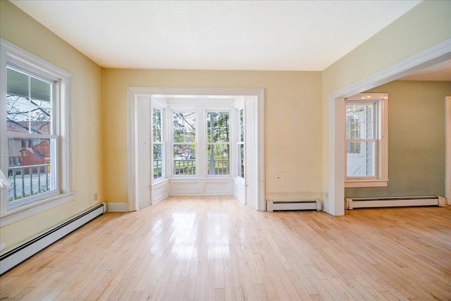 239-241 Hurleyville Main St, Hurleyville, NY 12747 - empty room with baseboard heating, hardwood / wood-style floors, and healthy amount of natural light