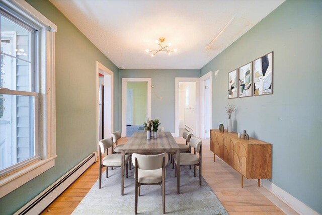 239-241 Hurleyville Main St, Hurleyville, NY 12747 - dining room with a baseboard radiator, light wood-style floors, a chandelier, and healthy amount of natural light