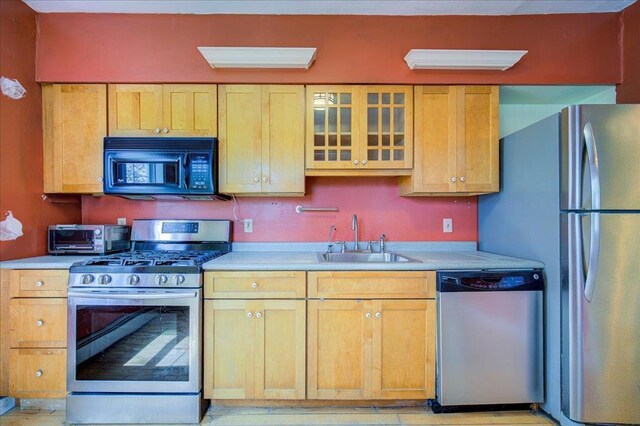 239-241 Hurleyville Main St, Hurleyville, NY 12747 - kitchen with stainless steel appliances, a sink, light countertops, and glass insert cabinets