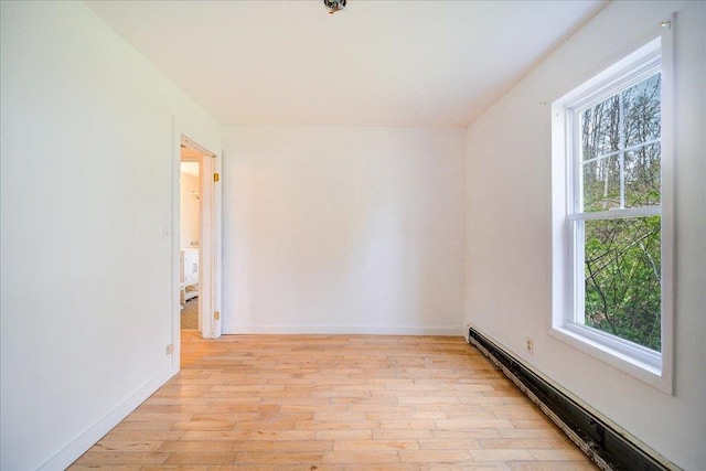 239-241 Hurleyville Main St, Hurleyville, NY 12747 - empty room featuring a baseboard radiator, light wood-style flooring, and baseboards