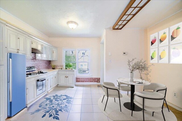 239-241 Hurleyville Main St, Hurleyville, NY 12747 - kitchen with freestanding refrigerator, wall oven, crown molding, light countertops, and under cabinet range hood