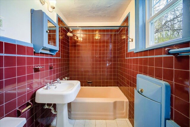 239-241 Hurleyville Main St, Hurleyville, NY 12747 - bathroom featuring tile walls, a textured ceiling, tile patterned floors, and tub / shower combination