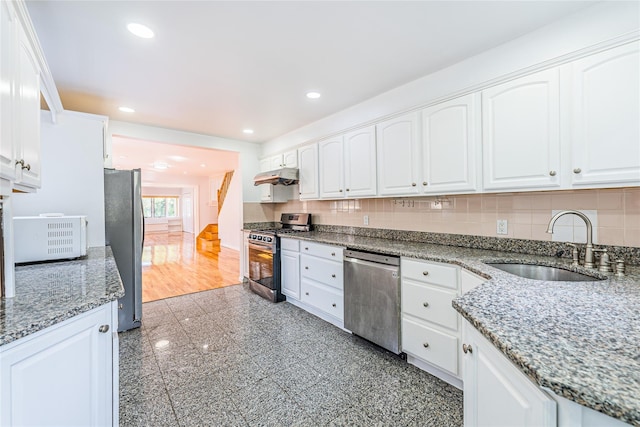 42-51247THST 247th St, Little Neck, NY 11363 - kitchen featuring appliances with stainless steel finishes, a sink, under cabinet range hood, white cabinets, and backsplash
