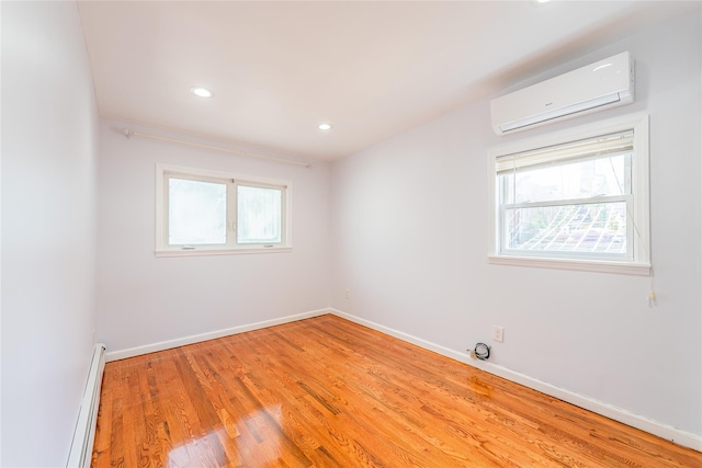 42-51247THST 247th St, Little Neck, NY 11363 - empty room featuring a wall mounted AC, a baseboard heating unit, light wood finished floors, baseboards, and recessed lighting