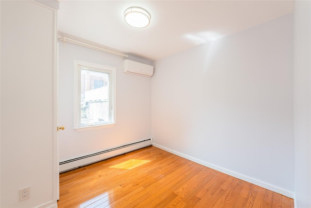 42-51247THST 247th St, Little Neck, NY 11363 - spare room featuring a baseboard radiator, a wall unit AC, light wood-style flooring, and baseboards