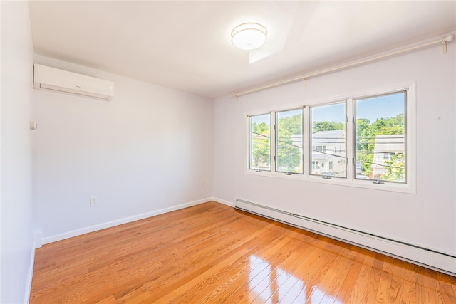42-51247THST 247th St, Little Neck, NY 11363 - spare room with baseboard heating, a wall mounted AC, light wood-type flooring, and baseboards