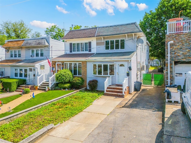 42-51247THST 247th St, Little Neck, NY 11363 - view of front facade featuring a front yard and asphalt driveway