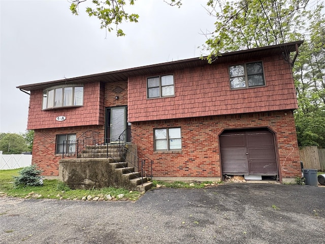 1A New Hwy, Commack, NY 11725 - split foyer home featuring a garage, brick siding, driveway, and fence