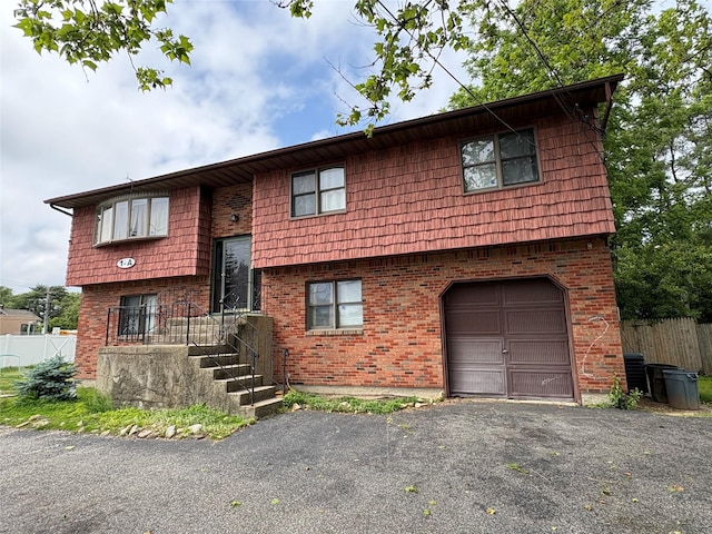 1A New Hwy, Commack, NY 11725 - view of front of house featuring a garage, brick siding, driveway, and cooling unit