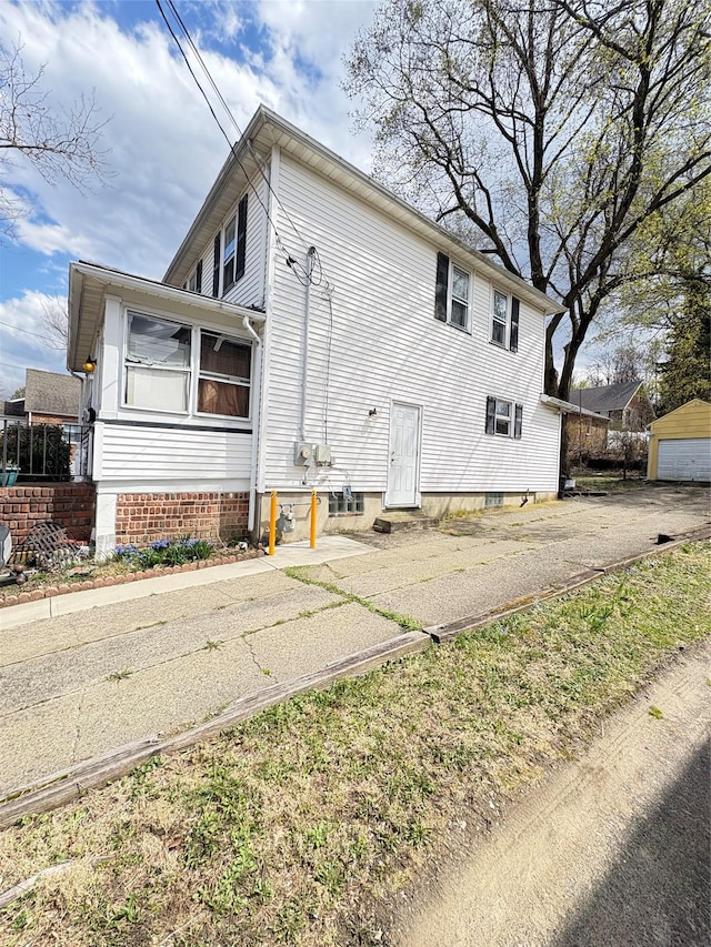 view of side of home with driveway and a garage