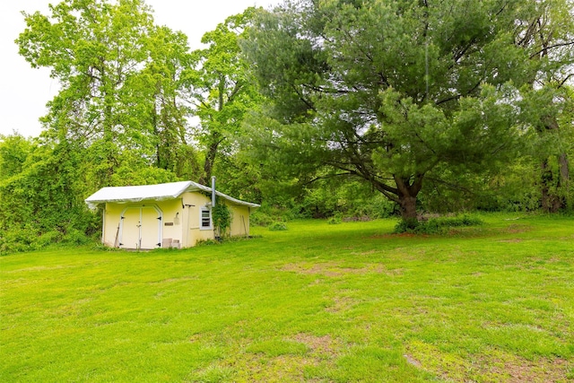 136 Foggintown Rd, Brewster, NY 10509 - view of green lawn with a storage shed and an outbuilding