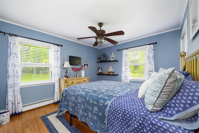 136 Foggintown Rd, Brewster, NY 10509 - bedroom featuring a baseboard heating unit, wood finished floors, crown molding, and ceiling fan