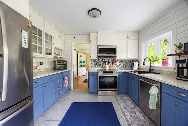 136 Foggintown Rd, Brewster, NY 10509 - kitchen with stainless steel appliances, blue cabinets, a sink, light tile patterned floors, and open shelves