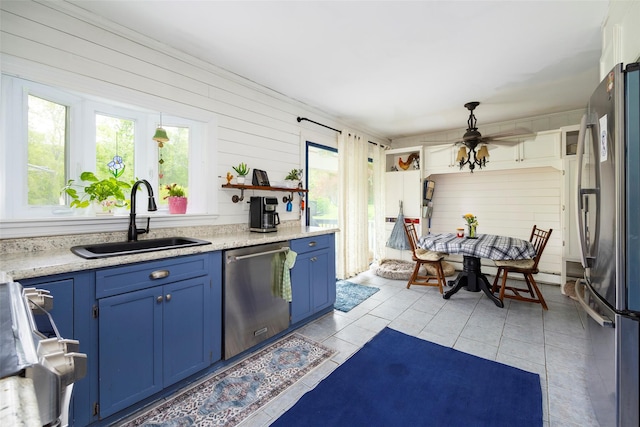 136 Foggintown Rd, Brewster, NY 10509 - kitchen with blue cabinets, appliances with stainless steel finishes, a sink, and light tile patterned floors