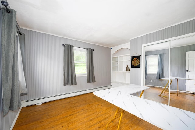 136 Foggintown Rd, Brewster, NY 10509 - spare room with a baseboard heating unit, ornamental molding, and wood finished floors