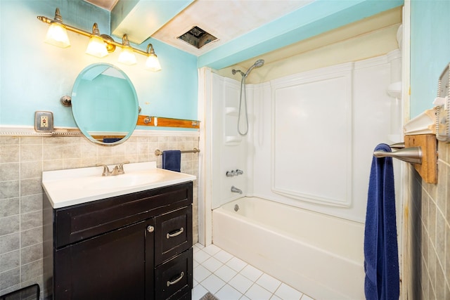 136 Foggintown Rd, Brewster, NY 10509 - full bath with tile walls, tile patterned flooring, wainscoting, vanity, and washtub / shower combination
